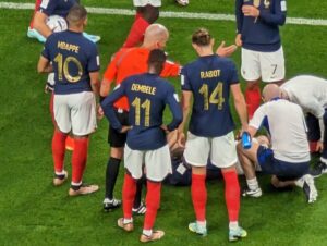 French players gather around an injured teammate at the FIFA World Cup in Qatar